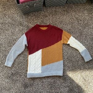 Cable knit, patchwork sweater, maroon, tan, white.